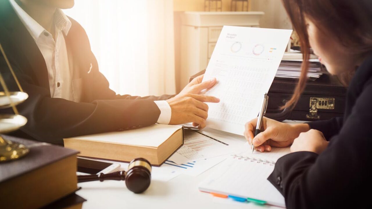 Consultation between a tax attorney and client discussing financial situation ezgif.com resize